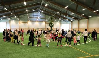 Jodå, det kan regna på midsommar! Men vad gör väl det när man kan flytta in hela firandet i fotbollshallen? 2018 var midsommarvädret som midsommarväder har en tendens att vara - ostadigt. Men då flyttade man helt enkelt in midsommarstången och reste den mitt inne i fotbollshallen så att midsommardansen kunde genomföras utan att besökarna blev blöta och kalla.